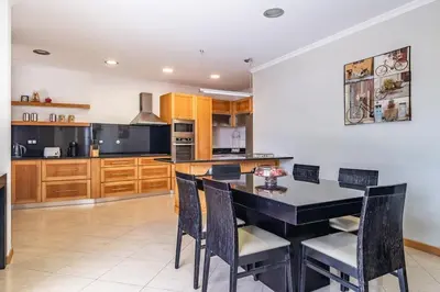 a kitchen with a black dining room table and chairs at Country Escape in Ribeira Brava