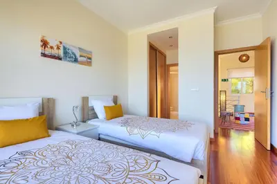 two beds sitting next to each other in a bedroom at Villa Araujo Da Costa by HR Madeira in Caniço