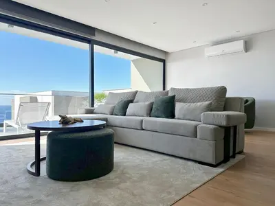 a living room with a couch and a table at Casa do Faial By Madeira Atlantic Escape in Funchal