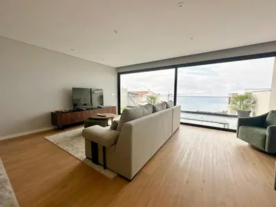 a living room with a couch and a large window at Casa do Faial By Madeira Atlantic Escape in Funchal