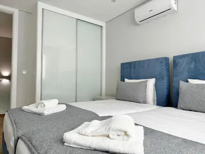 a bedroom with two white towels on a bed at Casa do Faial By Madeira Atlantic Escape in Funchal