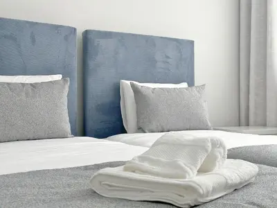 a bed with a white blanket on top of it at Casa do Faial By Madeira Atlantic Escape in Funchal