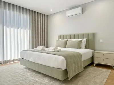 a bedroom with a large bed and a window at Casa do Faial By Madeira Atlantic Escape in Funchal