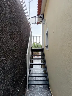a staircase leading up to a building with a stair case at Vanda House com 2 Quartos Vista Mar e montanha no centro da Ilha in Tábua