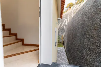 a staircase leading up to a house with a concrete wall at Vanda House com 2 Quartos Vista Mar e montanha no centro da Ilha in Tábua