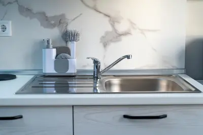a stainless steel sink in a kitchen at Vanda House com 2 Quartos Vista Mar e montanha no centro da Ilha in Tábua