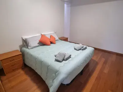 a bed with pillows on it in a room at Apto Vista Baía Machico by Susys Holidays in Machico