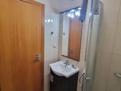 a bathroom with a sink and a shower and a mirror at Apto Vista Baía Machico by Susys Holidays in Machico