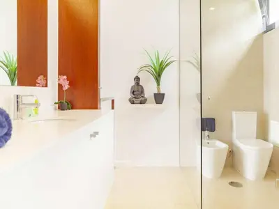 a bathroom with a glass shower and a toilet at Quinta Golfinho - Casa Frangipani in Arco da Calheta