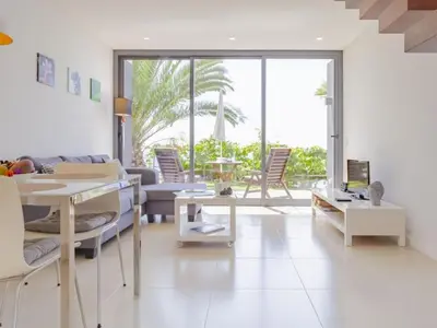 a living room with a couch and a table at Quinta Golfinho - Casa Frangipani in Arco da Calheta