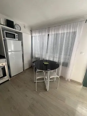 a bathroom with a toilet and a washing machine at Serenity Apartment in Funchal