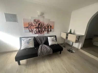 a white kitchen with a sink and a refrigerator at Serenity Apartment in Funchal