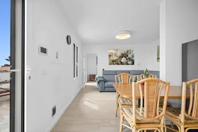 a dining room with a table and chairs and a couch at Casa Do Cabeco in Lapeiras