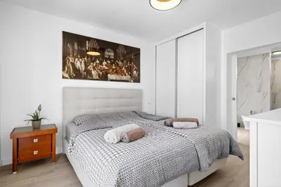 a bedroom with a bed and a painting on the wall at Casa Do Cabeco in Lapeiras