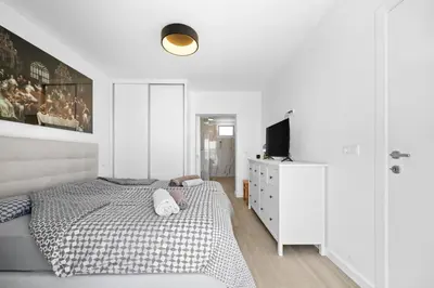 a white bedroom with a bed and a tv at Casa Do Cabeco in Lapeiras