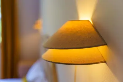 a yellow lamp sitting next to a wall at GuestReady - A sweet escape in Caniço in Santa Cruz
