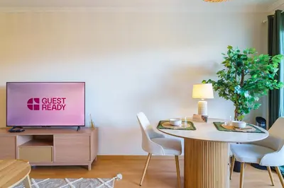 a living room with a table and a tv at GuestReady - A sweet escape in Caniço in Santa Cruz
