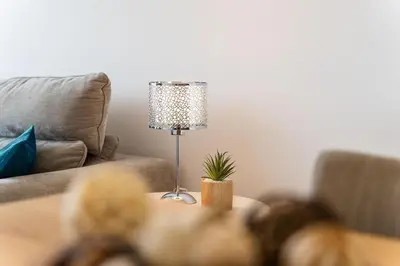 a lamp sitting on a table in a living room at GuestReady - Perfect family home in Caniço in Santa Cruz