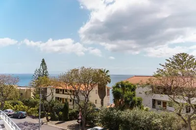 a woman walking down a street next to a building at GuestReady - Perfect family home in Caniço in Santa Cruz
