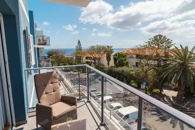 a balcony with chairs and a view of the ocean at GuestReady - Perfect family home in Caniço in Santa Cruz