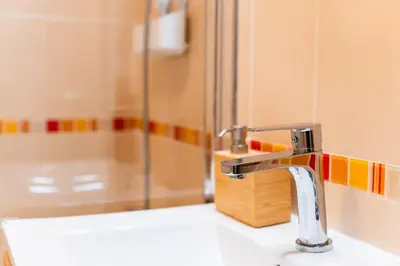 a bathroom sink with a faucet and a shower at GuestReady - The perfect hideout in Caniço in Caniço