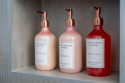 three bottles of liquid sitting on a shelf at Golden Tide in Machico