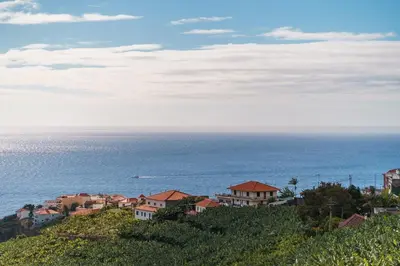 a town on a hill next to the ocean at GuestReady - Seaview Escape in Câmara de Lobos