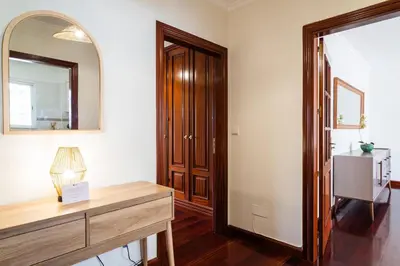 a room with a mirror and a dresser and a hallway at GuestReady - Lovely experience in Funchal in Funchal