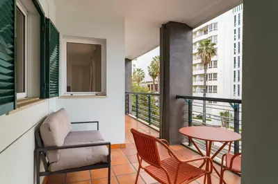 a balcony with a table and chairs and a table at GuestReady - Lovely experience in Funchal in Funchal