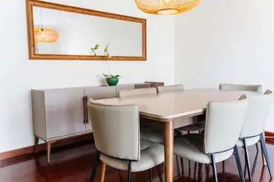 a dining room table with chairs and a mirror at GuestReady - Lovely experience in Funchal in Funchal