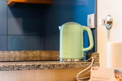 a green appliance sitting on a kitchen counter at GuestReady - Peaceful haven in Funchal in Funchal