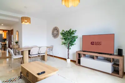 a living room with a table and a tv at GuestReady - Peaceful haven in Funchal in Funchal