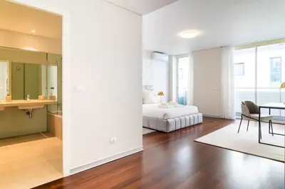 a bedroom with a bed and a dining room at GuestReady - Premium stay in Funchal in Funchal