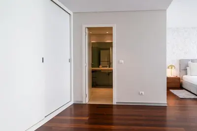 a living room with white walls and a wooden floor at GuestReady - Premium stay in Funchal in Funchal