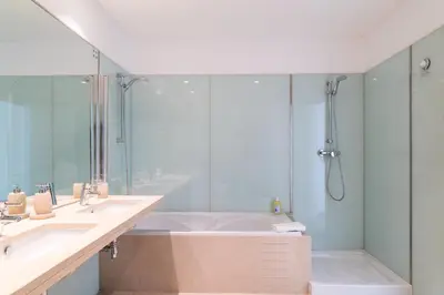 a bathroom with a tub and two sinks and a shower at GuestReady - Premium stay in Funchal in Funchal