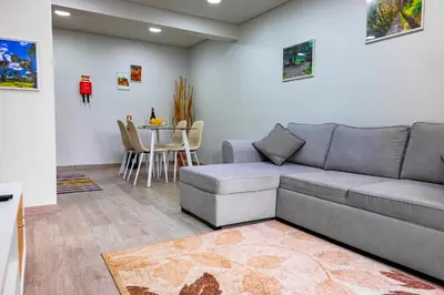 a living room with a couch and a table at LaurissilvaLodge in Senhora do Rosário