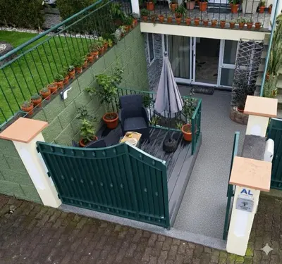 an overhead view of a balcony with an umbrella and chairs at LaurissilvaLodge in Senhora do Rosário
