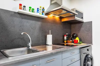 a kitchen with a sink and a counter top at LaurissilvaLodge in Senhora do Rosário