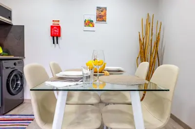 a dining room table with chairs and a glass table at LaurissilvaLodge in Senhora do Rosário