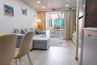 a living room with a couch and a table at LaurissilvaLodge in Senhora do Rosário