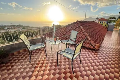 a roof with two chairs and a table on a roof at Ferienhaus Treibholz in Funchal