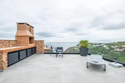 a patio with a view of the water at Casa Susan in Ribeira Brava