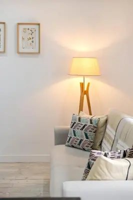 a living room with a couch and a lamp at Casa Susan in Ribeira Brava