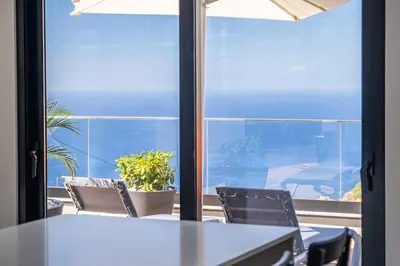 a room with a table and chairs and a window at Casa Isabel in Ribeira Brava
