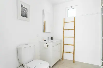 a bathroom with a white toilet and a ladder at GuestReady - Hillside Escape I in Câmara de Lobos