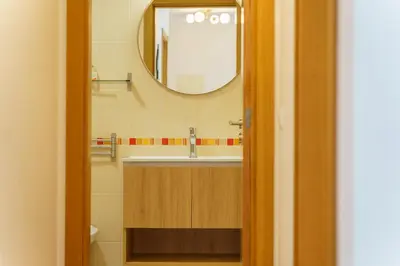a bathroom with a sink and a mirror at GuestReady - Madeiran mountain view with pool in Santa Cruz