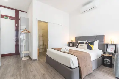 a bedroom with a large bed and a couch at Santa Cruz Studio 2 by Atlantic Holiday in Santa Cruz