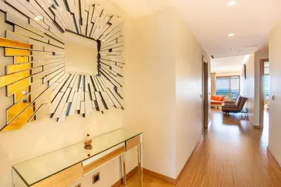 a living room with a large clock on the wall at Bianka & Jose Apartment Funchal Madeira in Funchal