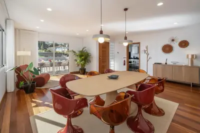a living room with a wooden table and chairs at Casa Tabaibo by An Island Apart in Funchal