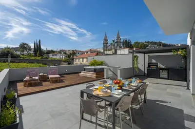 a patio with a table and chairs on a balcony at Casa Tabaibo by An Island Apart in Funchal